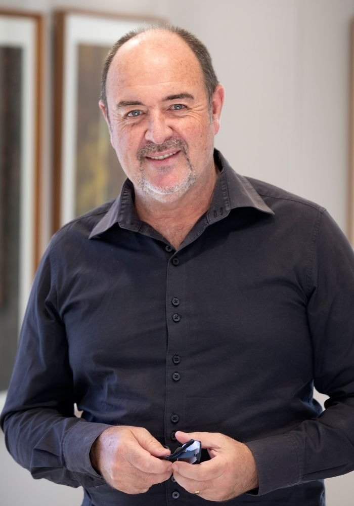 Martin Osner, photographer and teacher, standing in his gallery